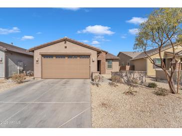 Charming single-story home featuring a well-maintained front yard and a two-car garage at 9008 W Bethany Heights Dr, Glendale, AZ 85305