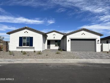 Charming single-story home featuring a three-car garage, desert landscaping, and neutral paint scheme at 9907 S 37Th Dr, Laveen, AZ 85339