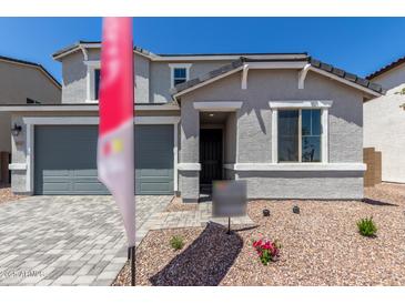 Charming two-story home featuring a gray stucco facade, a two-car garage, and a welcoming entryway at 11627 W Beck Ave, Youngtown, AZ 85363