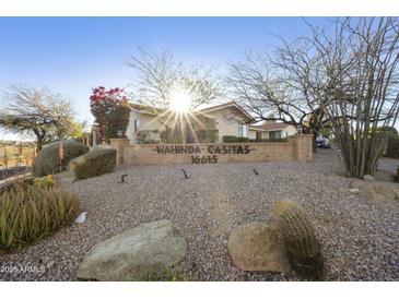 Welcoming Wahinda Casitas entrance sign surrounded by desert landscaping and mature trees at 16615 E Gunsight Dr # 205, Fountain Hills, AZ 85268