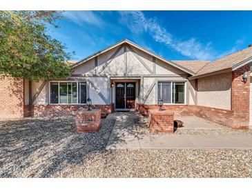 Charming front exterior featuring brick accents, landscaped front yard, and a welcoming entryway at 62 W Secretariat Dr, Tempe, AZ 85284