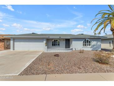 Charming single-story home with white painted brick and beautiful desert landscaping at 8064 E Madero Ave, Mesa, AZ 85209