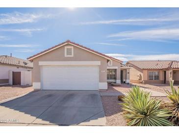 Charming single-story home with desert landscaping and a two-car garage under a clear blue sky at 8551 E Kiowa Ave, Mesa, AZ 85209
