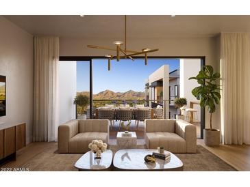 Bright living room featuring stylish seating, modern lighting, and an open balcony with mountain views at 19355 N 73Rd Way # 4016, Scottsdale, AZ 85255