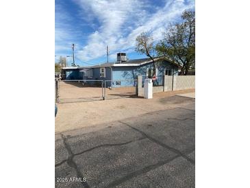 Charming single-story home featuring a fenced yard and street view at 2684 W Broadway Ave, Apache Junction, AZ 85120