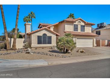 Charming two-story home featuring a well-maintained yard and a classic tile roof at 4530 E Vista Dr, Phoenix, AZ 85032