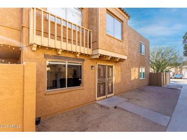Two-story condo featuring a secure entryway and a small, private balcony at 4615 E Southgate Ave, Phoenix, AZ 85040
