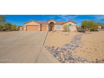 Charming single-story home with a three-car garage and desert landscaping at 730 E Tanya Trl, Phoenix, AZ 85086