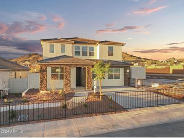 Charming home featuring a well-kept yard, stylish fence, and eye-catching architectural details at 7441 W Buckhorn Trl, Peoria, AZ 85383