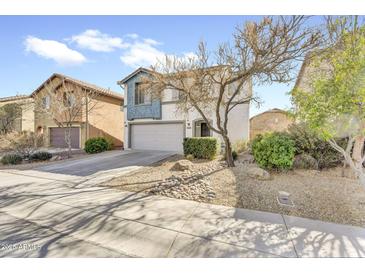 Charming two-story home with a well-manicured front yard and a two-car garage in a residential neighborhood at 7961 W Desert Blossom Way, Florence, AZ 85132