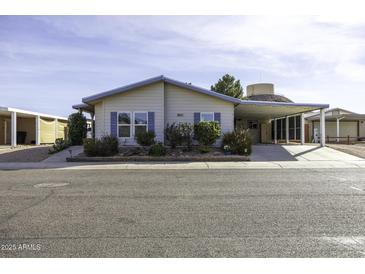 Inviting single-story home featuring desert landscaping and a covered carport at 891 W Moon Shadow Dr, Casa Grande, AZ 85122