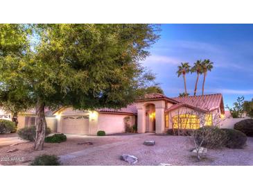 Charming single-story home with a well-manicured lawn, tile roof, and attached two-car garage at 9445 S La Rosa Dr, Tempe, AZ 85284