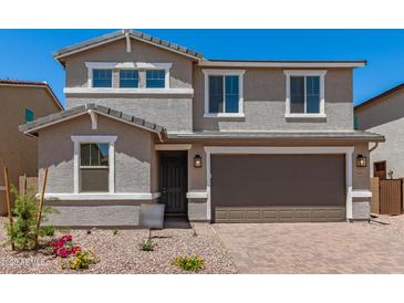 Charming two-story home featuring a two-car garage, landscaped front yard, and neutral color palette at 11615 W Beck Ave, Youngtown, AZ 85363