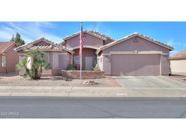 Charming single-story home with neutral stucco, desert landscaping, and a two-car garage in a quiet residential neighborhood at 123 S Lucia Ln, Casa Grande, AZ 85194