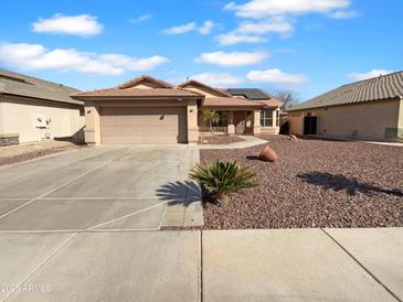 Charming single-story home featuring a two-car garage, well-kept landscaping, and a cozy entrance at 12914 W Wilshire Dr, Avondale, AZ 85392