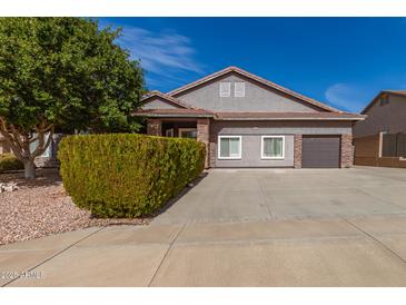 Charming single-Gathering home featuring a two-car garage, manicured landscaping and a tile roof at 6456 E Orion St, Mesa, AZ 85215