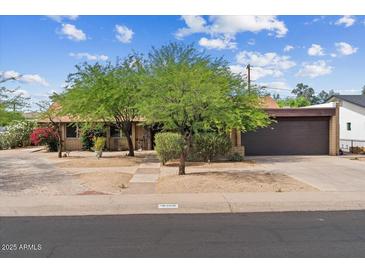 Charming single-story home with a two-car garage and mature trees in the front yard at 7226 E Virginia Ave, Scottsdale, AZ 85257