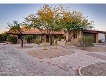 Charming single-story brick home with a well-maintained yard and mature shade trees at 7226 E Virginia Ave, Scottsdale, AZ 85257