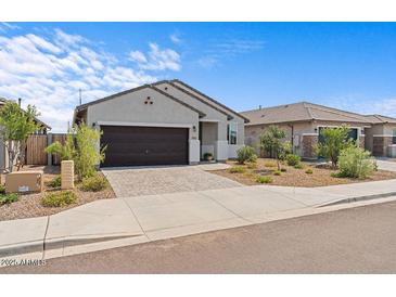 Charming single-story home featuring a two-car garage and a low maintenance landscaped front yard at 13171 W Buckskin Trl, Peoria, AZ 85383