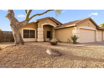 Charming single-story home featuring a desert landscape and a two-car garage at 21630 N 30Th Ln, Phoenix, AZ 85027