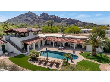 Aerial view of a stunning backyard pool area with lounge chairs and mountain views at 4726 E Sierra Vista Dr, Paradise Valley, AZ 85253