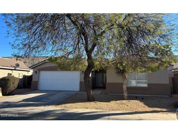 Charming single-story home with a well-maintained front yard and a two-car garage at 6531 W Hess S St, Phoenix, AZ 85043
