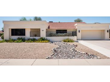 Charming single-story home featuring a low-maintenance desert landscape and inviting curb appeal at 12423 W Morning Dove Dr, Sun City West, AZ 85375