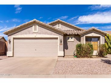 Inviting single-story home featuring a two-car garage, neutral paint, and low-maintenance desert landscaping at 2 E Coral Bean Dr, San Tan Valley, AZ 85143