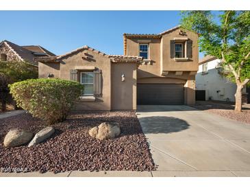 Charming stucco home featuring a well-manicured yard and a two-car garage at 2134 E Honeysuckle Pl, Chandler, AZ 85286