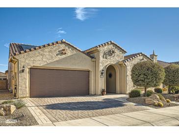 Charming single-story stucco home featuring a paved driveway, desert landscaping, and a two-car garage at 26828 W Piute Ave, Buckeye, AZ 85396
