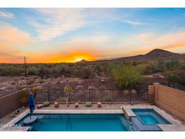 Inviting backyard pool and spa with desert landscape views offering a private oasis at 31106 N 138Th Ave, Peoria, AZ 85383