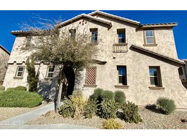 Charming two-story home with a stucco facade, landscaped yard, and mature trees at 4744 E Tierra Buena Ln, Phoenix, AZ 85032