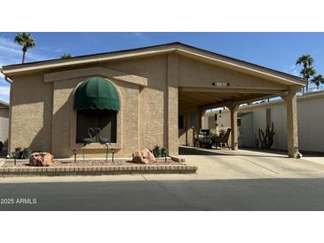 Charming home exterior featuring a covered carport, arched accent, and manicured front garden at 6161 S Pinehurst Dr, Chandler, AZ 85249