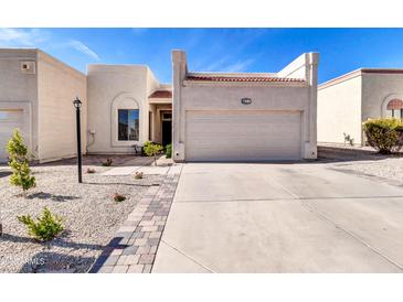 Charming single-story home with a two-car garage and desert landscaping at 7006 E Jensen St # 33, Mesa, AZ 85207