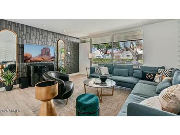 Inviting living room featuring stylish decor, a comfortable sectional, and a large window for ample natural light at 7601 E 2Nd St # 20, Scottsdale, AZ 85251