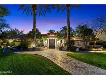 Beautiful single story home with mature trees and manicured lawn leading to a grand entrance at 8306 N Merion Way, Paradise Valley, AZ 85253