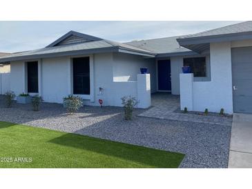 Charming single-story home with well-maintained landscaping and a welcoming entryway at 4007 W Rue De Lamour Ave, Phoenix, AZ 85029