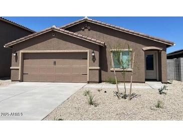 Charming single-story home with a low maintenance front yard and an attached two-car garage at 1082 W 20Th St, Florence, AZ 85132