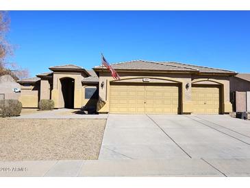 Charming single-story home featuring a three-car garage and a desert-landscaped front yard at 10916 E Cholla Rd, Mesa, AZ 85207