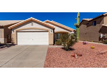 Charming single-story home with a two-car garage and desert landscaping at 2120 E Daley Ln, Phoenix, AZ 85024