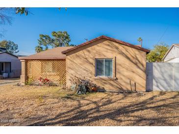 Charming home featuring a lattice-covered porch and a well-maintained yard at 2318 E Flower St, Phoenix, AZ 85016