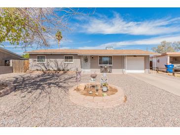 Charming single-story home featuring a low-maintenance front yard and attached one car garage at 7546 E Clovis Cir, Mesa, AZ 85208