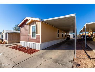 Tan and brown single-story home featuring covered parking and manicured landscaping at 8218 S 7Th St # Ofc, Phoenix, AZ 85042