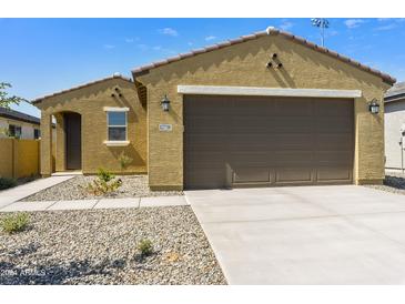 Charming single-story home featuring a two-car garage, desert landscaping, and a covered front entry at 12738 N 172Nd Dr, Surprise, AZ 85388