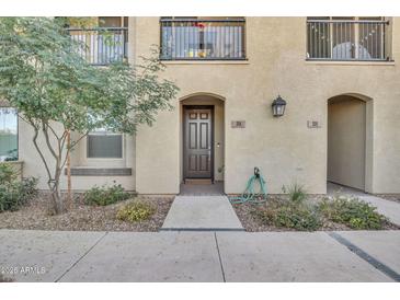 Charming townhome exterior featuring a private entrance, landscaped walkway, and balcony at 155 N Lakeview Blvd # 206, Chandler, AZ 85225
