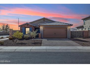 Charming single-story home with well-manicured landscaping and a two-car garage at 18153 W Fulton St, Goodyear, AZ 85338