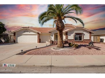 Charming single-story home with a well-manicured yard and a desert landscape at 2506 S Acanthus --, Mesa, AZ 85209