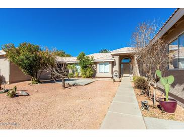 Charming single-story home with desert landscaping and a welcoming walkway to the front entrance at 4016 E Forest Pleasant Pl, Cave Creek, AZ 85331