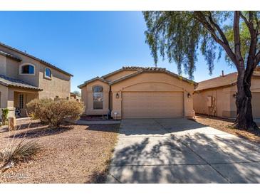 Charming single-story home with low-maintenance landscaping, tile roof and two car garage at 911 E Lovegrass Dr, San Tan Valley, AZ 85143