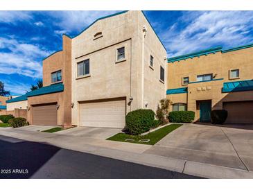 Two story condo with attached garage and a well-manicured front lawn at 1015 S Val Vista Dr # 81, Mesa, AZ 85204